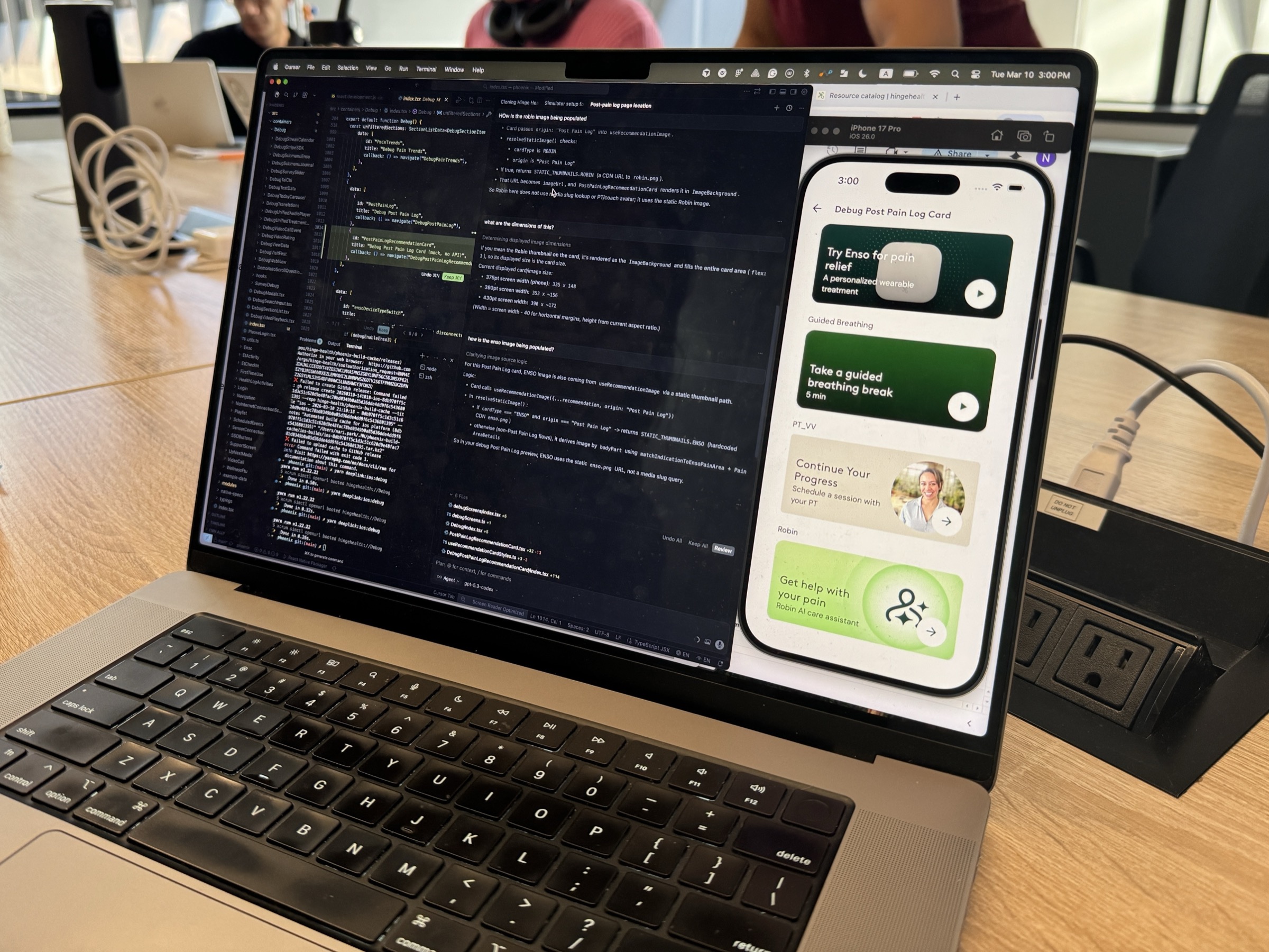 A designer's laptop showing an AI coding agent alongside a live app preview